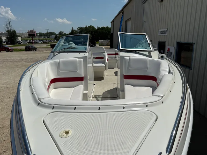 Slide: The Image of 2001 Formula F-260 boat with white and red seating, parked outdoors. - 3