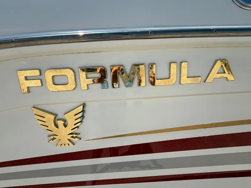 Slide: The Image of 2001 Formula F-260 boat emblem with gold lettering and eagle logo on white hull. - 4