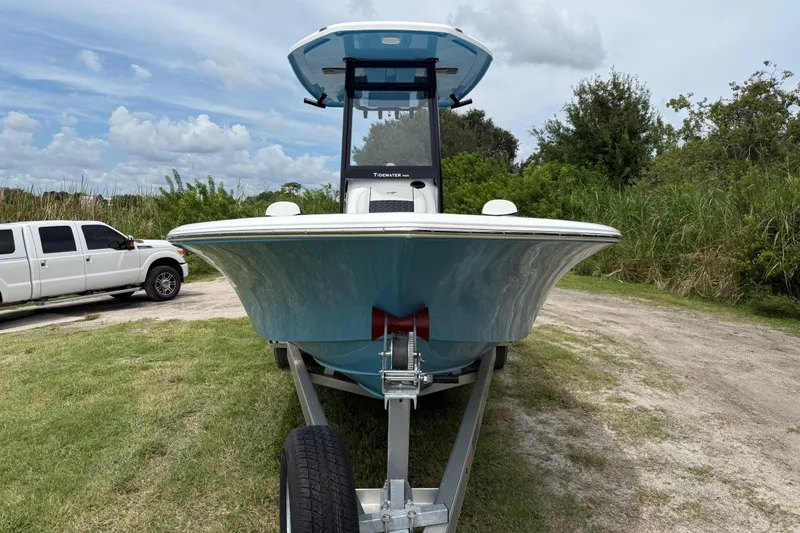 Slide: The Image of 2026 Tidewater 2300 Carolina Bay boat on trailer, parked near grassy area. - 10