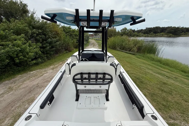 Slide: The Image of 2026 Tidewater 2300 Carolina Bay boat on grassy path by water. - 13