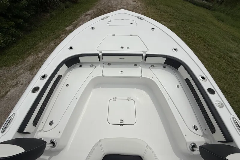 Slide: The Image of 2026 Tidewater 2300 Carolina Bay boat deck with storage compartments and seating. - 16