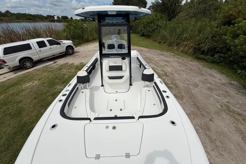 Slide: The Image of 2026 Tidewater 2300 Carolina Bay boat on grassy shore near a white truck. - 18