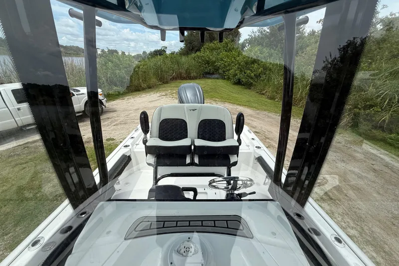 Slide: The Image of 2026 Tidewater 2300 Carolina Bay boat interior with dual seats and steering wheel. - 21