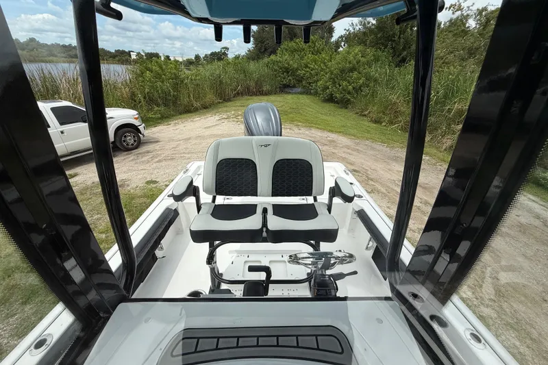 Slide: The Image of 2026 Tidewater 2300 Carolina Bay boat interior with seating and steering wheel. - 22