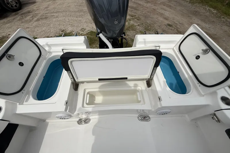 Slide: The Image of 2026 Tidewater 2300 Carolina Bay boat interior with storage compartments and seating. - 25