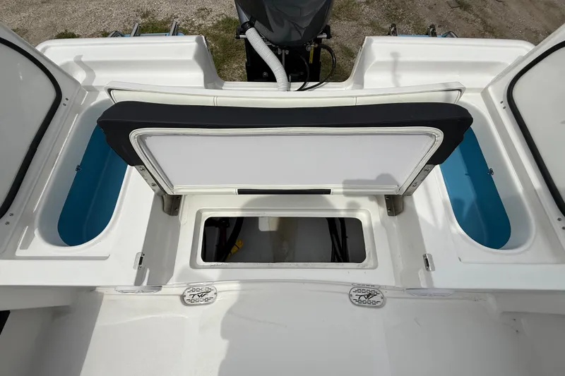 Slide: The Image of 2026 Tidewater 2300 Carolina Bay boat interior with storage compartments and seating. - 26