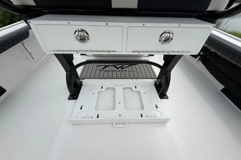 Slide: The Image of 2026 Tidewater 2300 Carolina Bay boat interior with storage compartments and branded mat. - 27