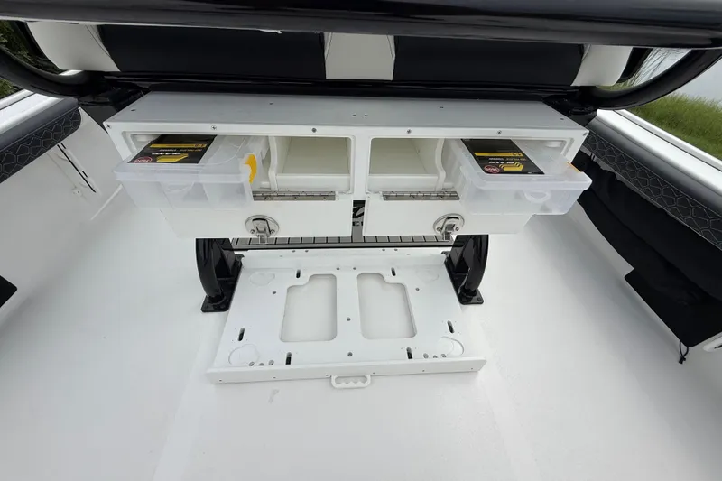 Slide: The Image of 2026 Tidewater 2300 Carolina Bay boat storage compartments with tackle boxes. - 28