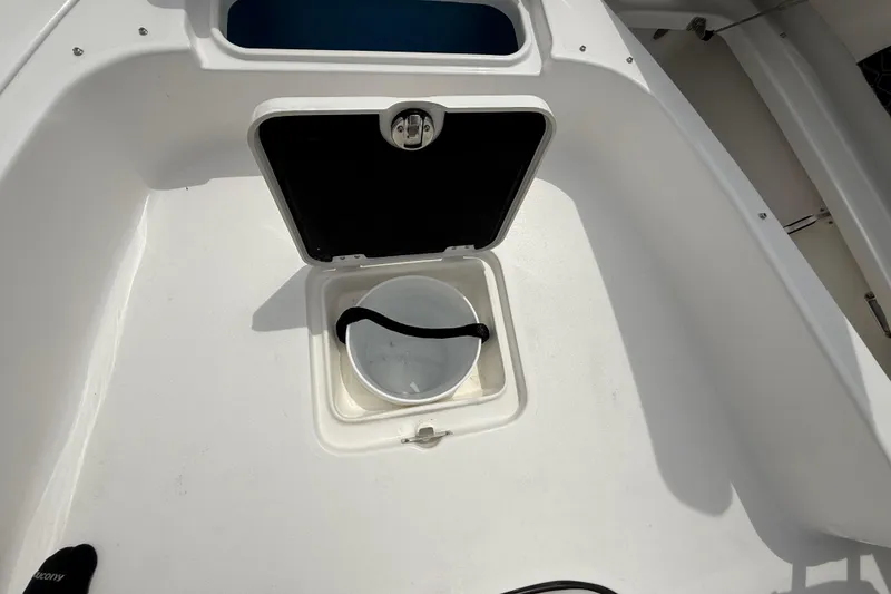 Slide: The Image of Storage compartment on 2026 Tidewater 2300 Carolina Bay boat with bucket inside. - 34