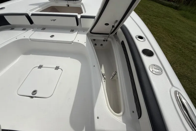 Slide: The Image of 2026 Tidewater 2300 Carolina Bay boat interior with open storage compartments. - 38