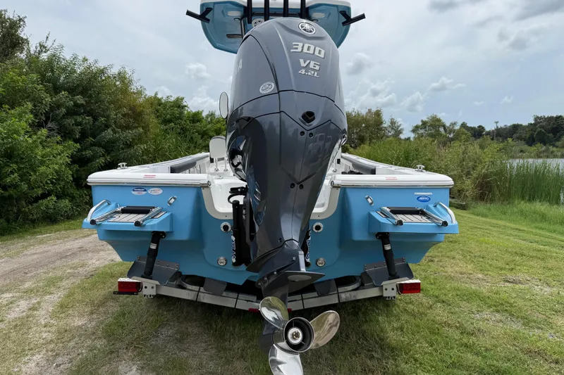 Slide: The Image of 2026 Tidewater 2300 Carolina Bay boat with Yamaha 300 V6 engine, parked on grass. - 4