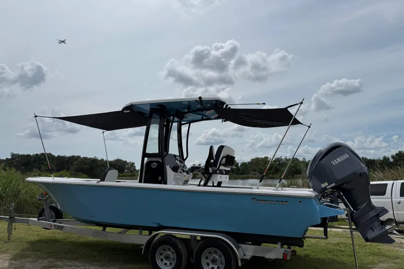 Slide: The Image of 2026 Tidewater 2300 Carolina Bay boat on trailer, with Yamaha engine, under cloudy sky. - 42