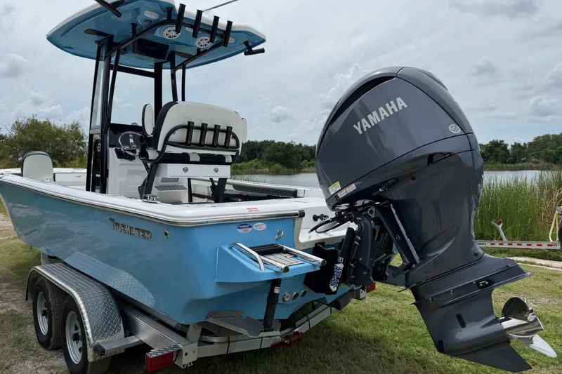 Slide: The Image of 2026 Tidewater 2300 Carolina Bay boat with Yamaha engine on trailer by a lake. - 5
