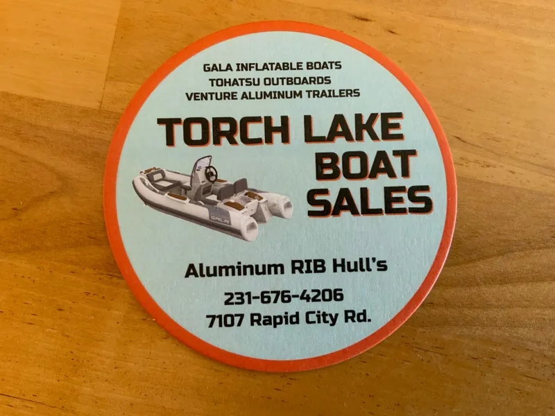 Slide: The Image of Coaster advertising Torch Lake Boat Sales, featuring Gala V420 inflatable boat, contact details included. - 13