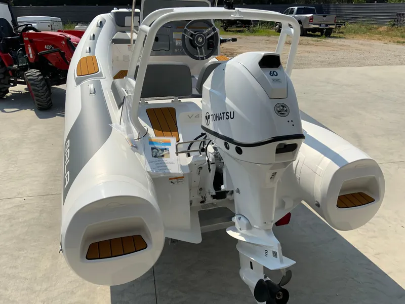 Slide: The Image of 2026 Gala V420 boat with Tohatsu engine, parked outdoors on concrete surface. - 15