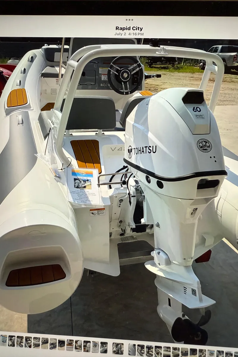 Slide: The Image of 2026 Gala V420 boat with Tohatsu engine, displayed outdoors in Rapid City. - 19
