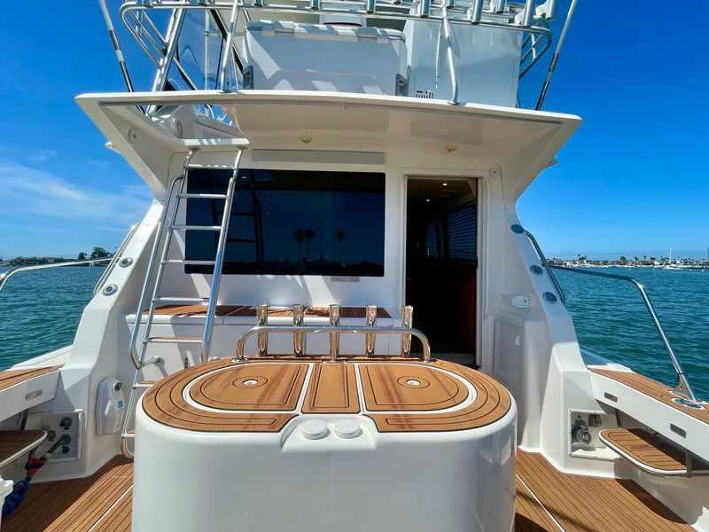 Slide: The Image of 1998 Viking 50 Convertible yacht with teak deck, ladder, and ocean view. - 10