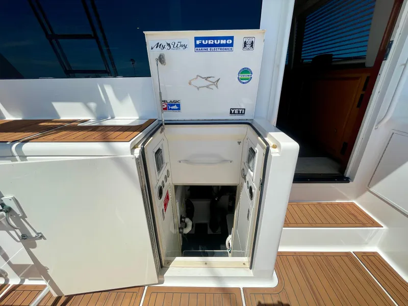 Slide: The Image of 1998 Viking 50 Convertible yacht with open hatch and control panel, teak deck visible. - 14