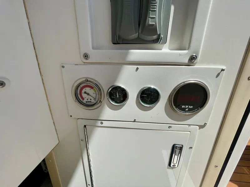 Slide: The Image of Control panel of a 1998 Viking 50 Convertible boat with gauges and RPM display. - 15