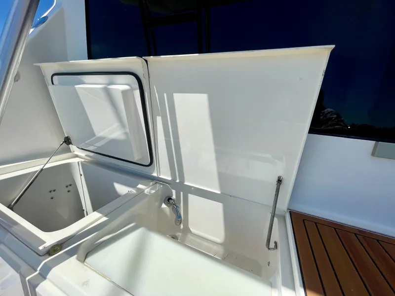 Slide: The Image of Open storage compartment on 1998 Viking 50 Convertible yacht, featuring sleek white design. - 17