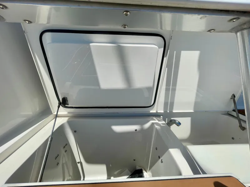 Slide: The Image of Open storage compartment on a 1998 Viking 50 Convertible boat, showing interior details. - 18