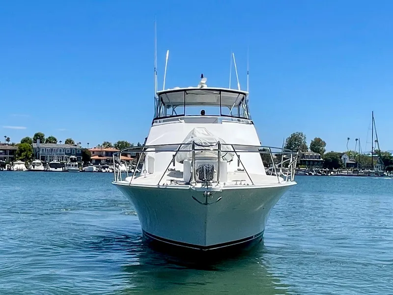 Slide: The Image of 1998 Viking 50 Convertible yacht on calm water, clear blue sky background. - 2