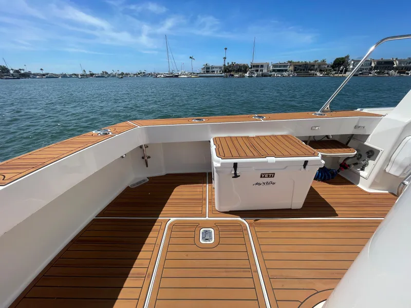 Slide: The Image of 1998 Viking 50 Convertible yacht deck with Yeti cooler, overlooking marina. - 23