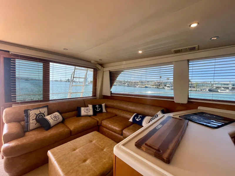 Slide: The Image of Luxurious interior of 1998 Viking 50 Convertible yacht with leather seating and nautical decor. - 32