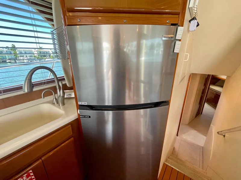 Slide: The Image of Kitchen area of a 1998 Viking 50 Convertible yacht with stainless steel fridge. - 35