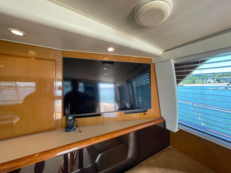 Slide: The Image of Interior of 1998 Viking 50 Convertible yacht with TV and scenic window view. - 38