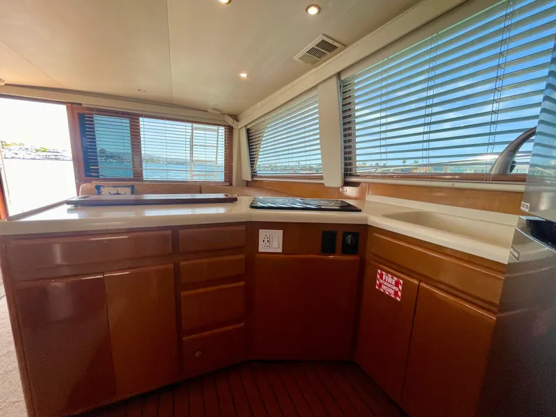 Slide: The Image of Interior of 1998 Viking 50 Convertible yacht with wooden cabinetry and large windows. - 39