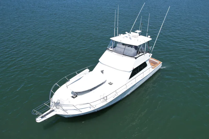 Slide: The Image of 1998 Viking 50 Convertible yacht on calm blue water. - 4