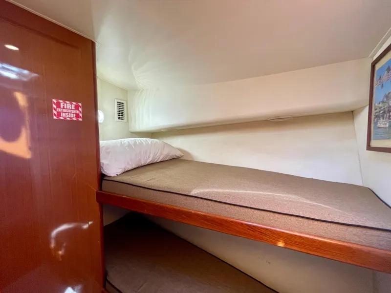 Slide: The Image of Cozy bunk bed in 1998 Viking 50 Convertible yacht cabin with fire extinguisher sign. - 41
