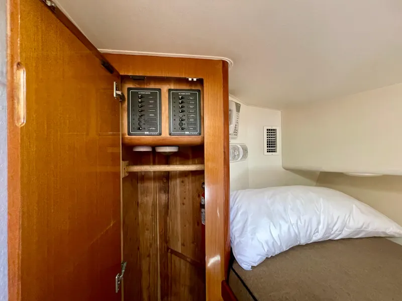 Slide: The Image of 1998 Viking 50 Convertible cabin interior with wooden closet and control panels. - 43