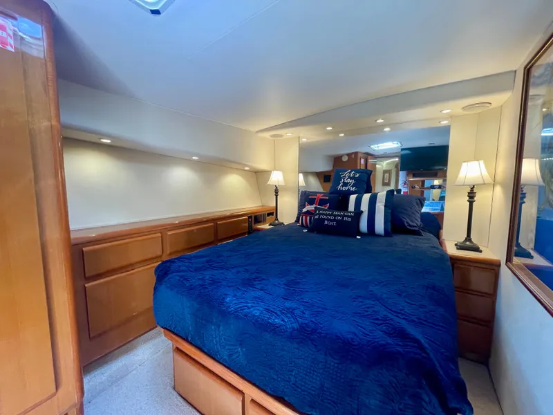 Slide: The Image of Luxurious bedroom interior of 1998 Viking 50 Convertible yacht with elegant bedding and lighting. - 45