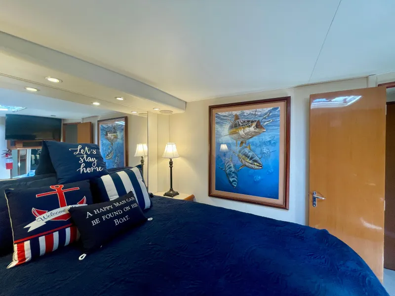 Slide: The Image of Cozy bedroom in 1998 Viking 50 Convertible yacht with nautical decor and fish artwork. - 47