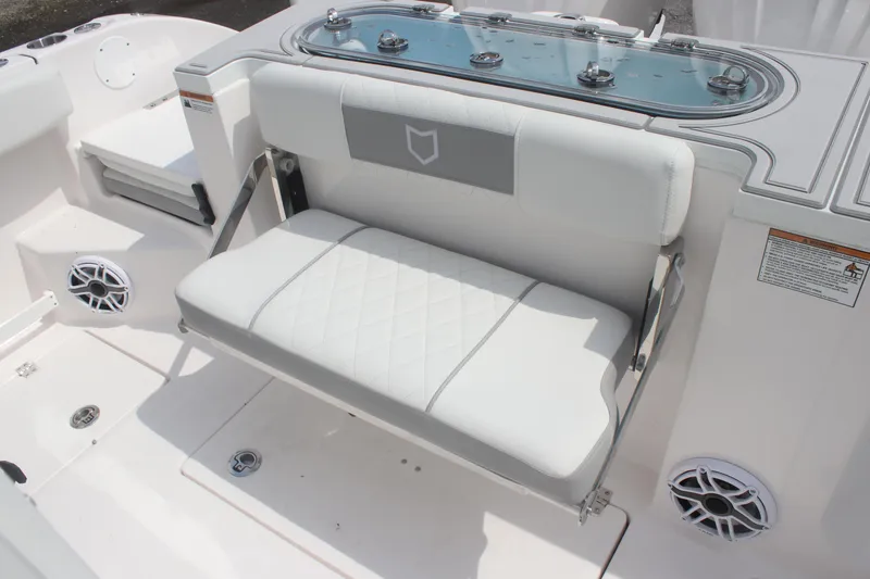 Slide: The Image of 2026 Sea Fox 288 Commander boat interior with white cushioned seating and built-in speakers. - 17