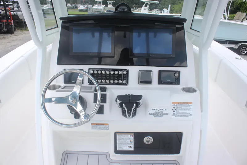 Slide: The Image of 2026 Sea Fox 288 Commander boat dashboard with steering wheel and electronic controls. - 23