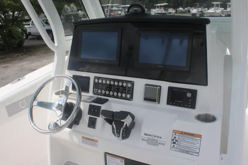 Slide: The Image of 2026 Sea Fox 288 Commander dashboard with dual screens and steering wheel. - 27