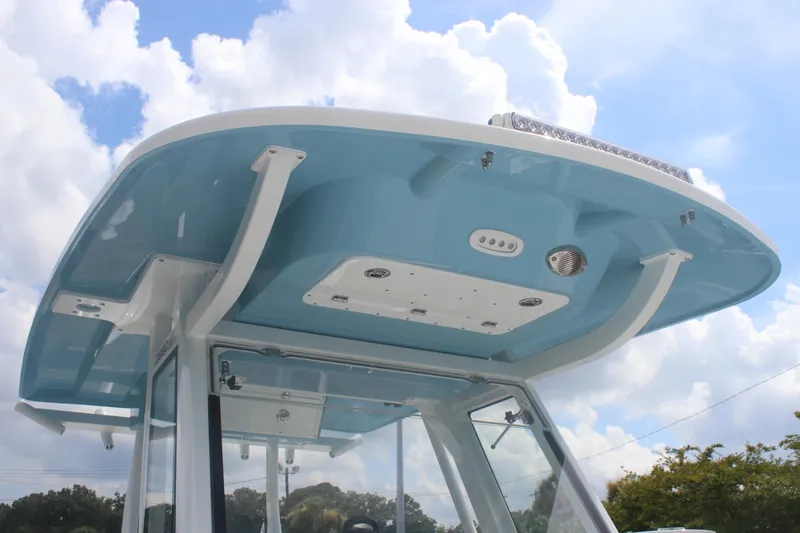 Slide: The Image of 2026 Sea Fox 288 Commander boat's blue hardtop against a cloudy sky. - 30
