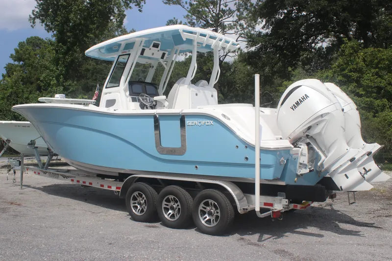 Slide: The Image of 2026 Sea Fox 288 Commander boat on trailer with Yamaha engines, parked outdoors. - 5