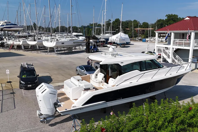Slide: The Image of 2026 Tiara Yachts 43 LE docked at a marina with other boats. - 1