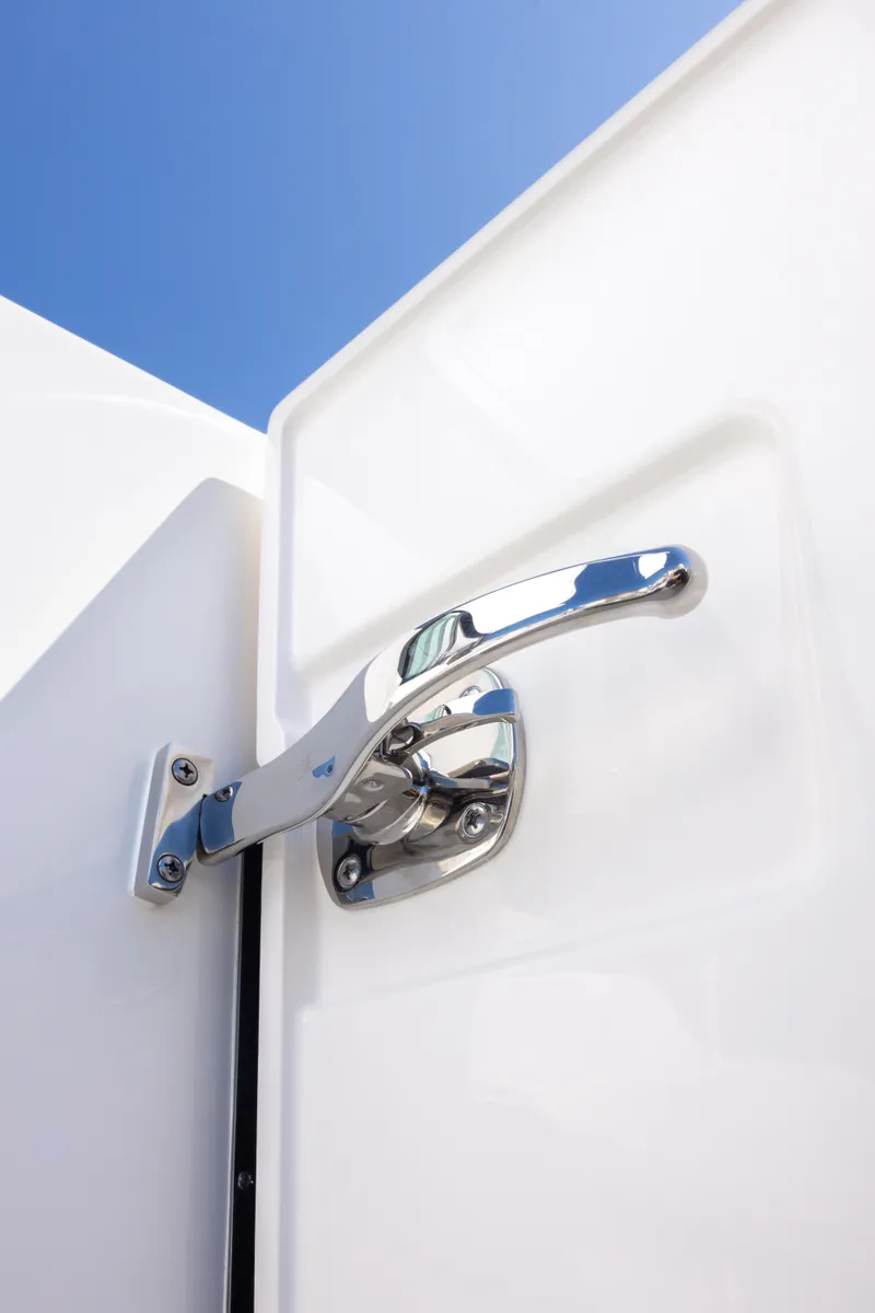 Slide: The Image of Chrome handle on 2025 Tiara Yachts 43 LE against clear blue sky. - 21