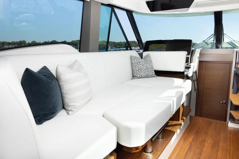 Slide: The Image of Luxurious interior of 2025 Tiara Yachts 43 LE with white seating and decorative pillows. - 23