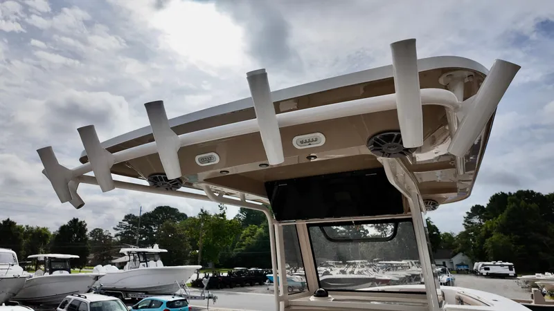Slide: The Image of 2024 Sea Chaser 35 HFC Bluewater Series boat with rod holders and speakers, under cloudy sky. - 11