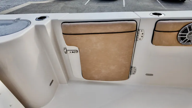 Slide: The Image of 2024 Sea Chaser 35 HFC Bluewater Series boat interior with tan cushioned panels and speaker. - 16
