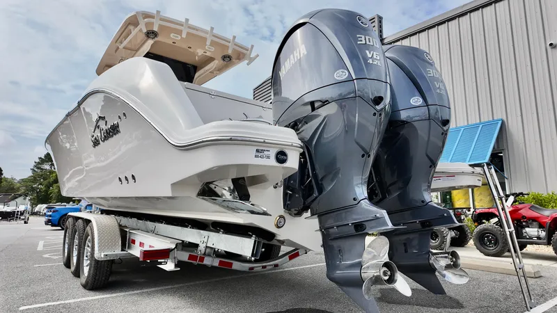 Slide: The Image of 2024 Sea Chaser 35 HFC Bluewater Series boat with dual Yamaha 300 engines on trailer. - 2