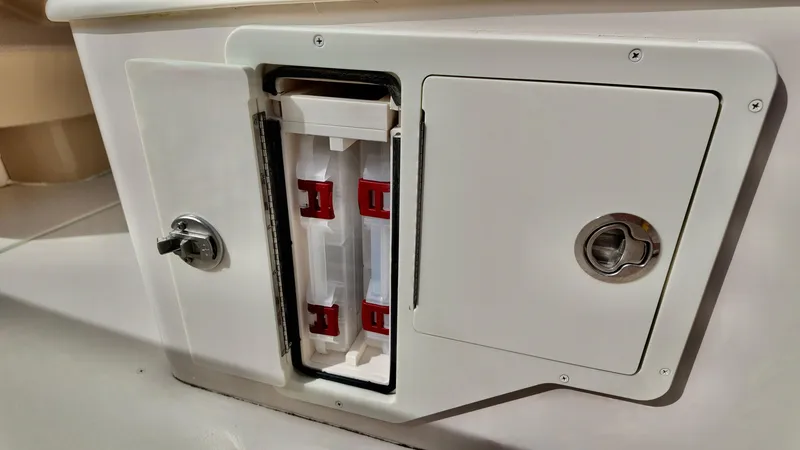 Slide: The Image of 2024 Sea Chaser 35 HFC Bluewater Series storage compartment with secure latch and organized interior. - 28