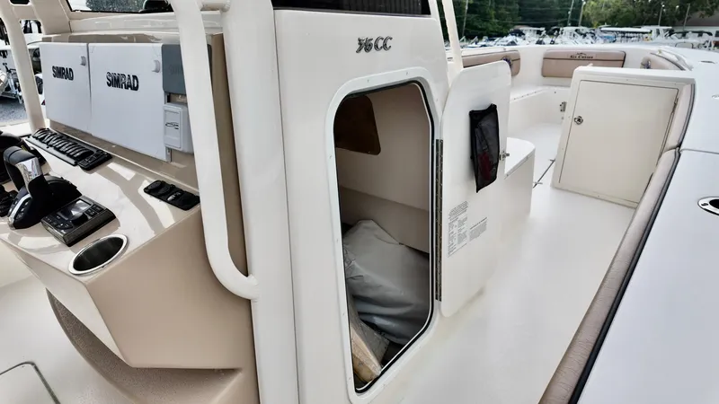 Slide: The Image of 2024 Sea Chaser 35 HFC Bluewater Series boat interior with Simrad electronics and storage compartment. - 9