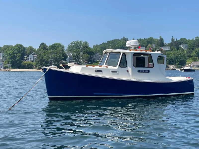 Slide: The Image of 2005 Atlas Boat Works Pompano 21, blue hull, moored on calm water, scenic background. - 15